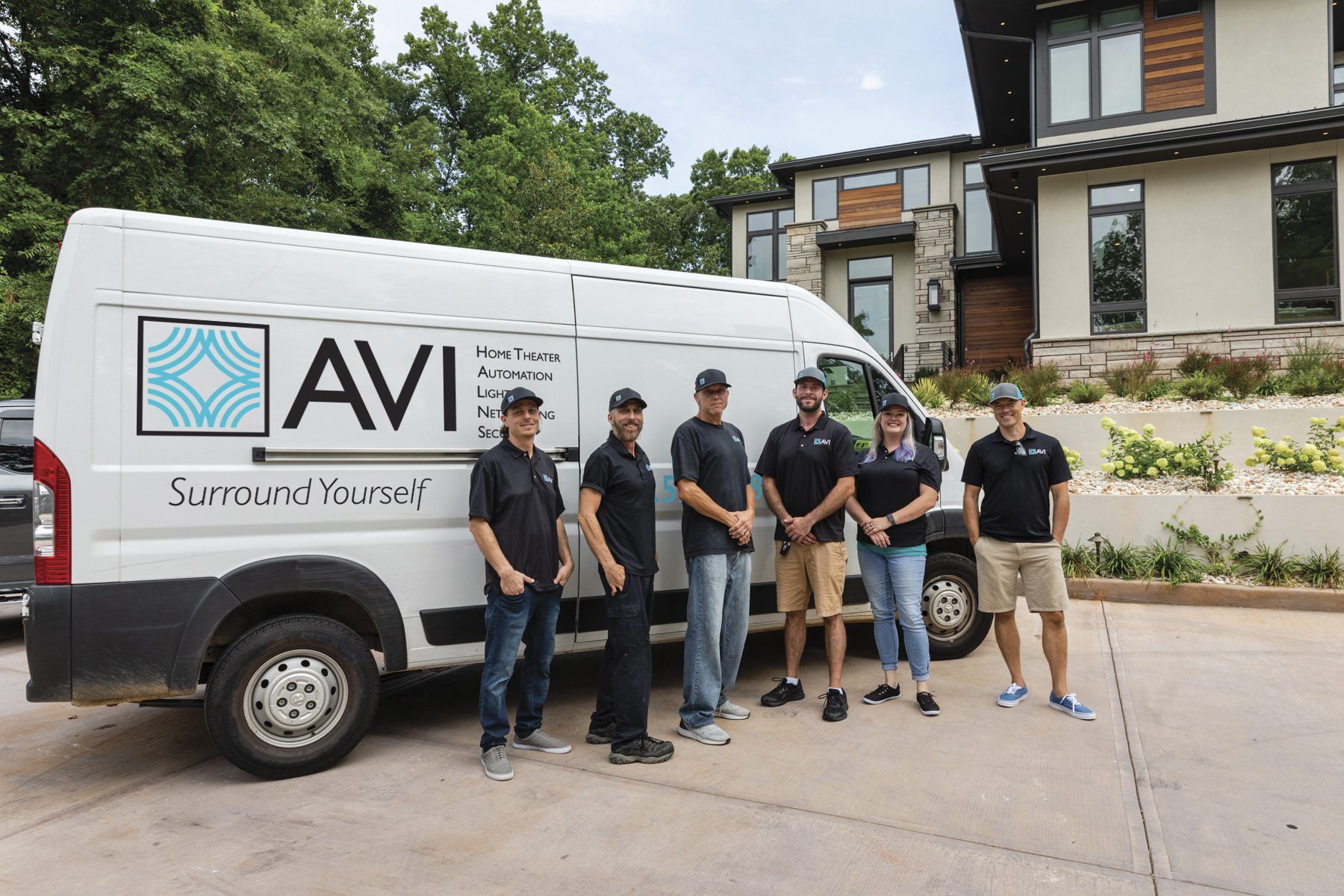 A group of people posing near a van