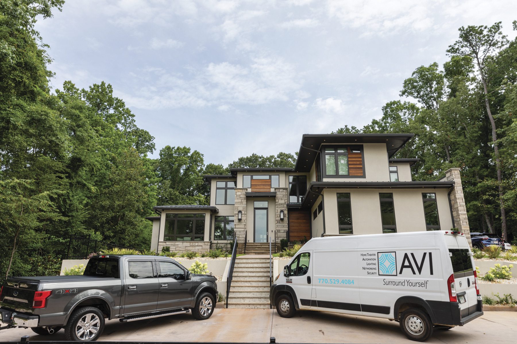 Audio Video Interiors van parked near a house