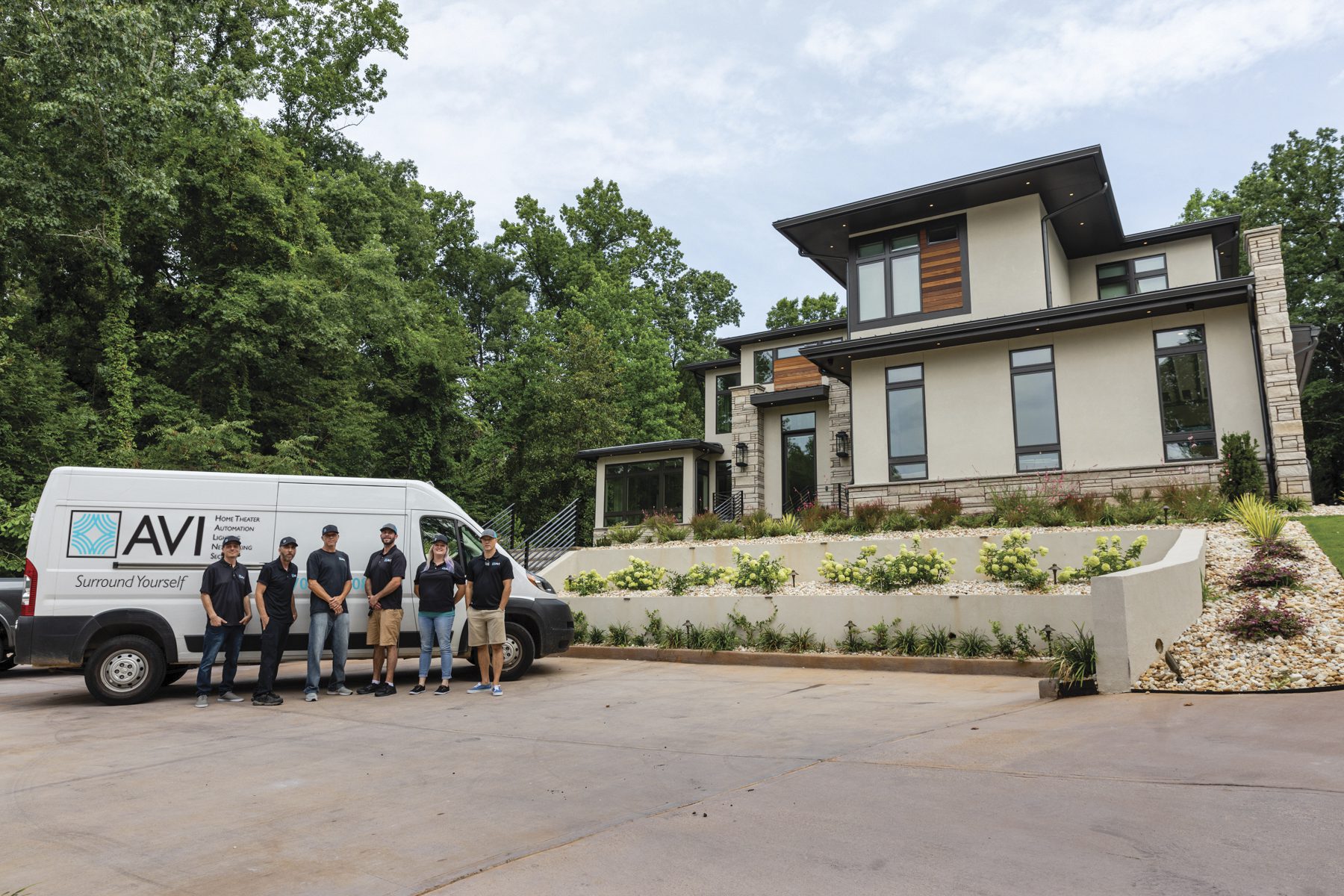 A group of people posing near a white color van