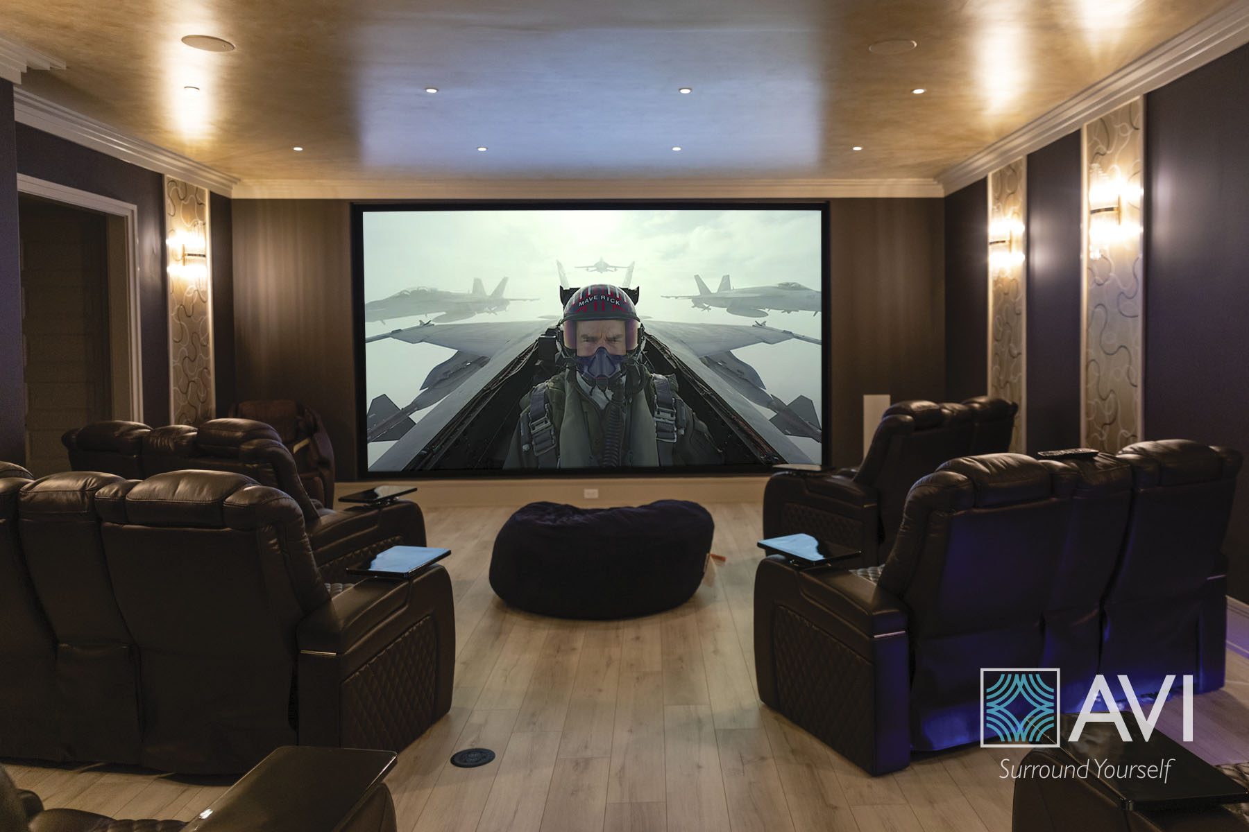 A theater system with leather sofas and bean bag